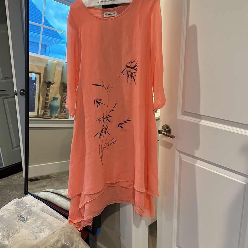 Fully line flowing shimmering layered dress with three-quarter length sleeves